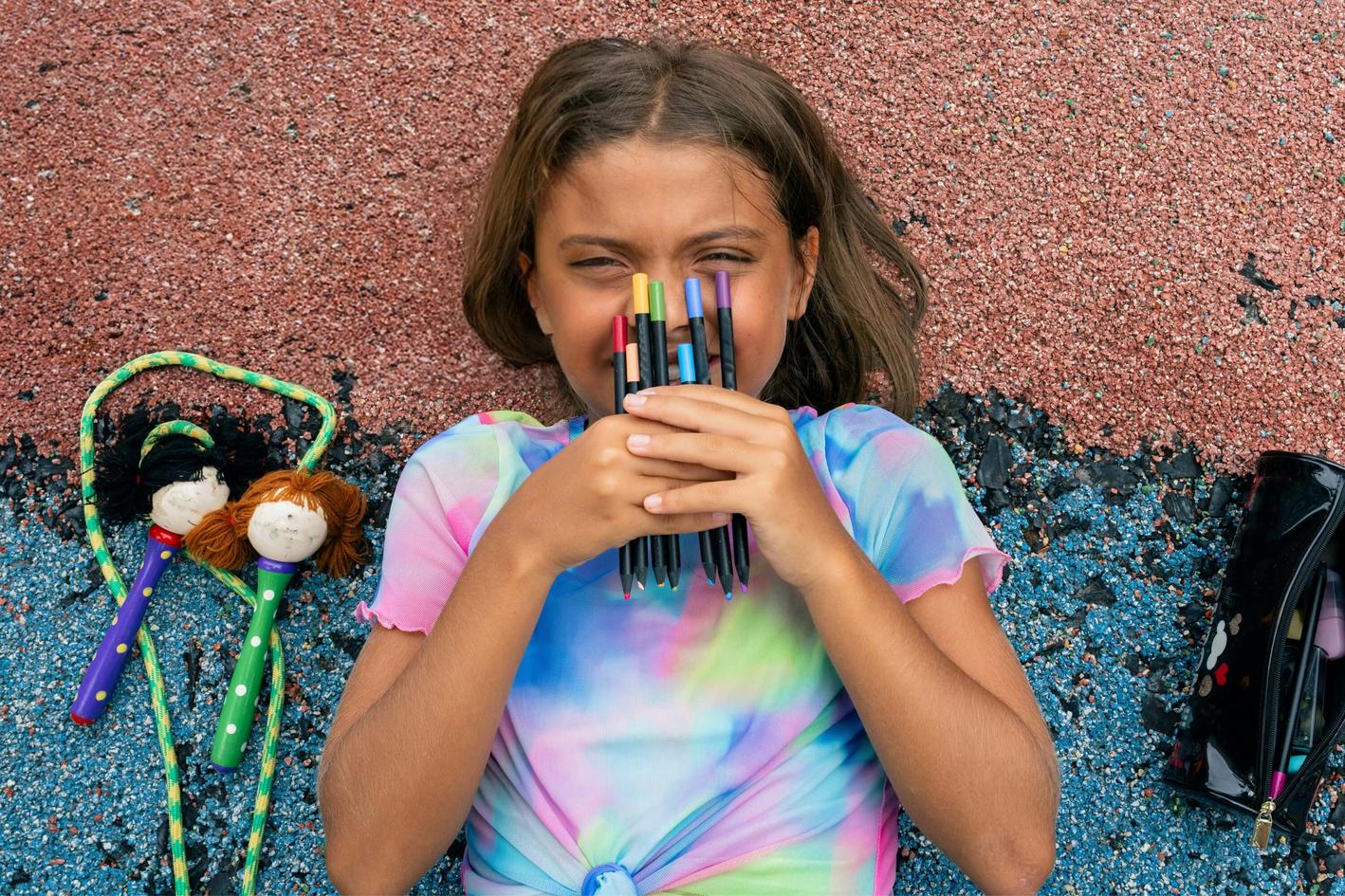 Young girl with pens